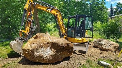 moving boulders with mini excavator|moving large boulders in yard.